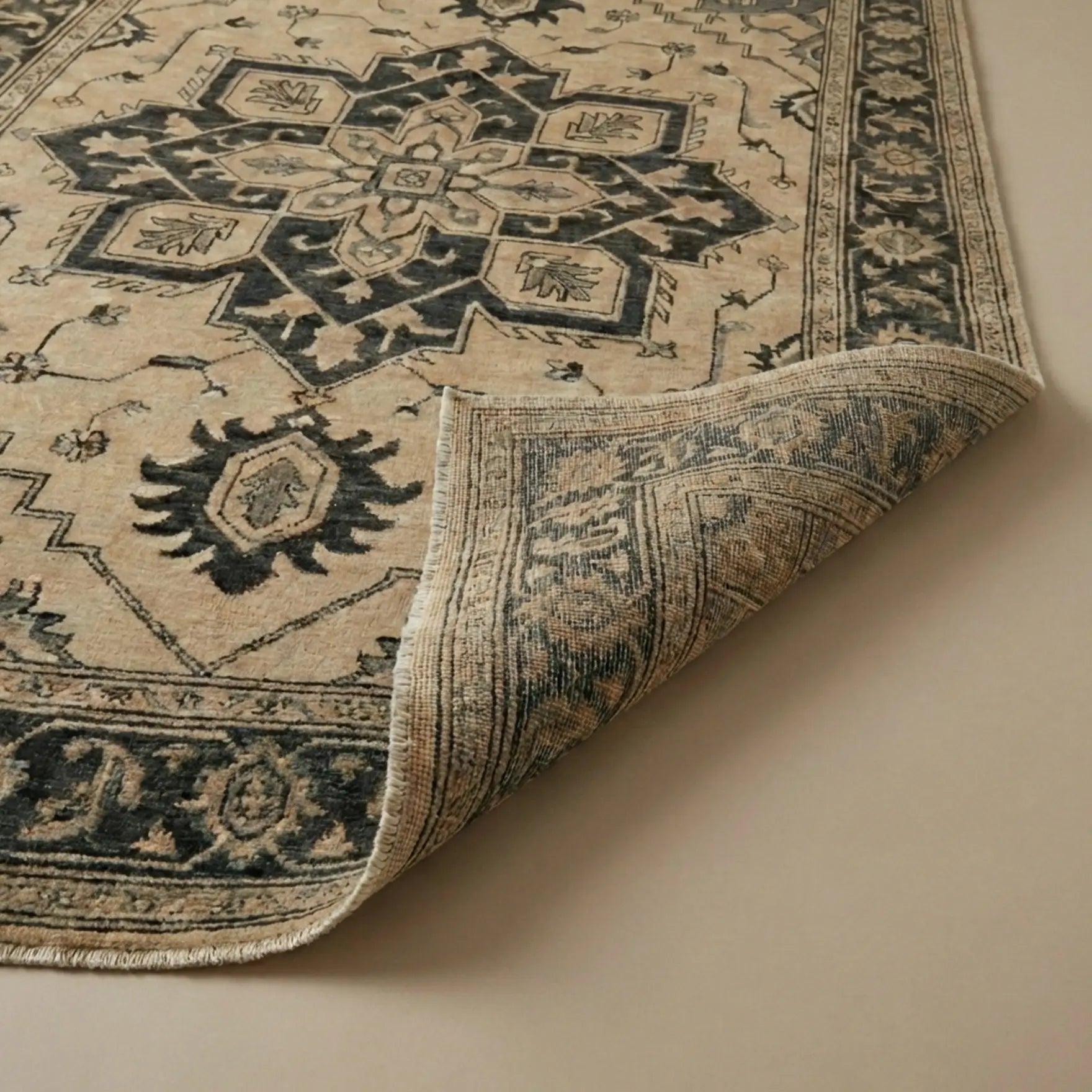 Close-up of a patterned rug with beige and black colors on a beige background